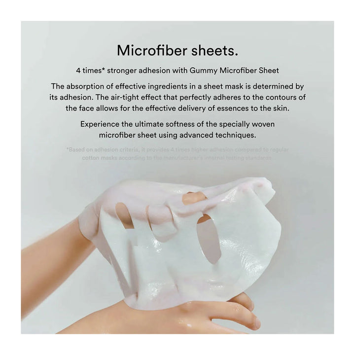 A white sheet mask being held against a light gray background, with descriptive text above explaining its microfiber sheet technology and strong adhesion.
