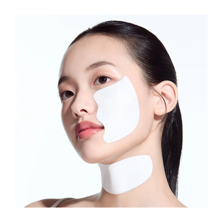Woman with white patches on her face against a white background