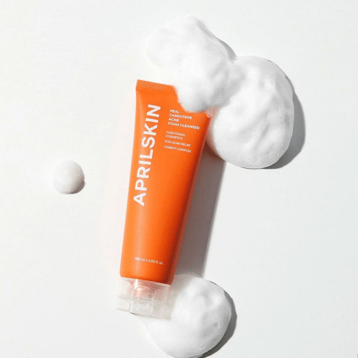 Orange AprilSkin tube with white foam on a light gray background