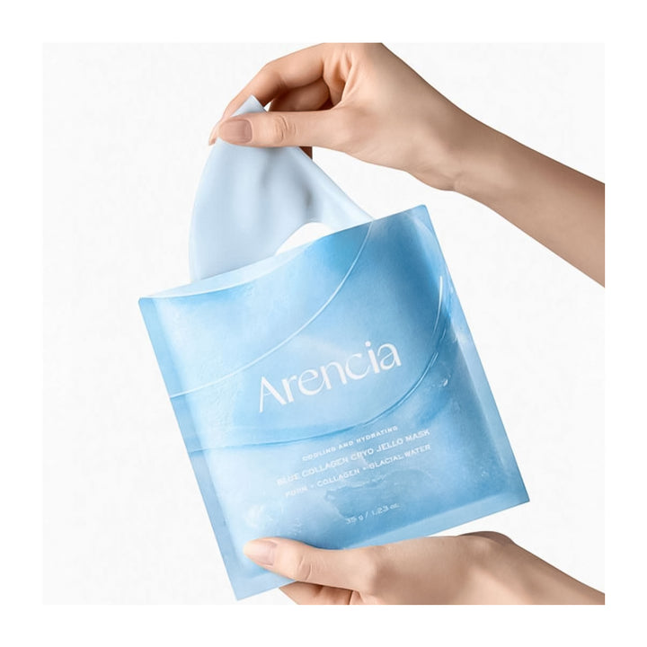 Hand holding a blue packaging of Arencia product on a white background