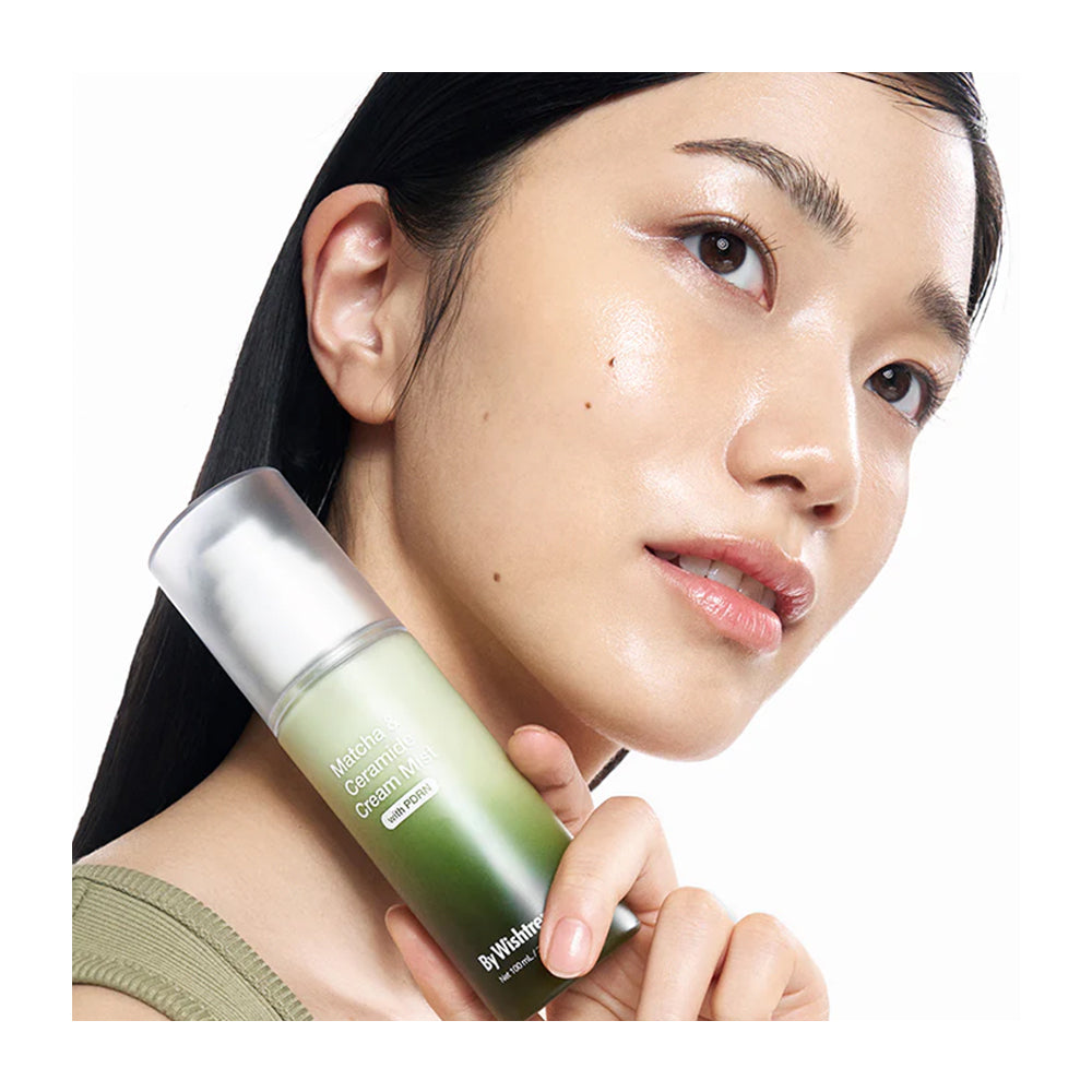 Woman holding a skincare product with a white background