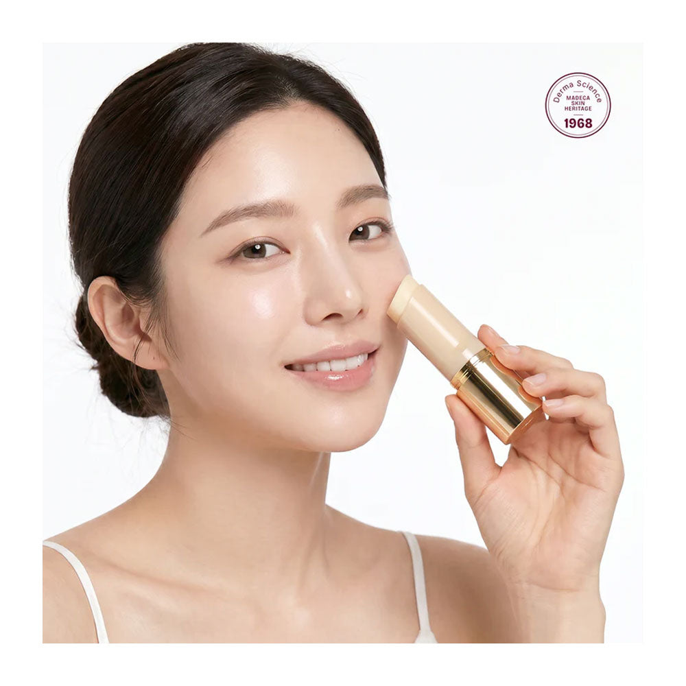 Woman applying cream to her face with a cosmetic brand logo in the corner.