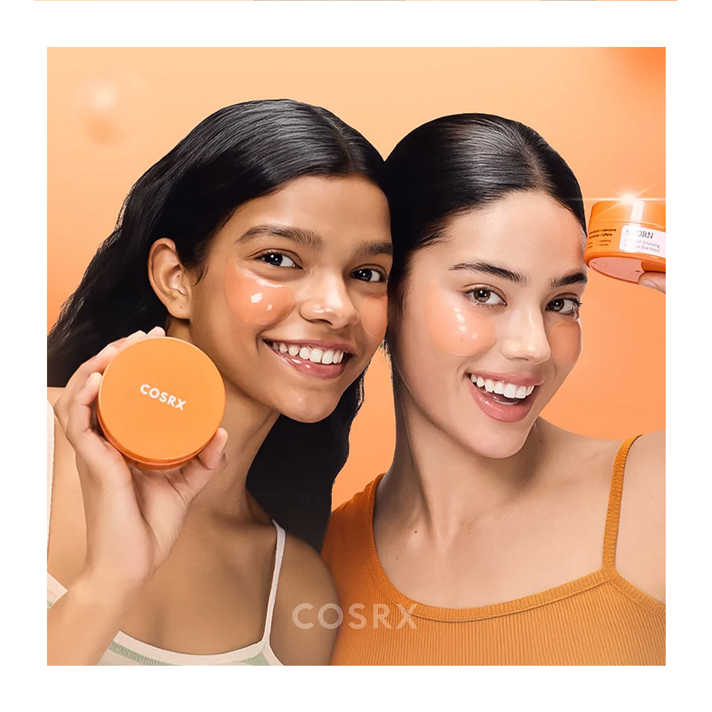 Two women holding COSRX products against an orange background