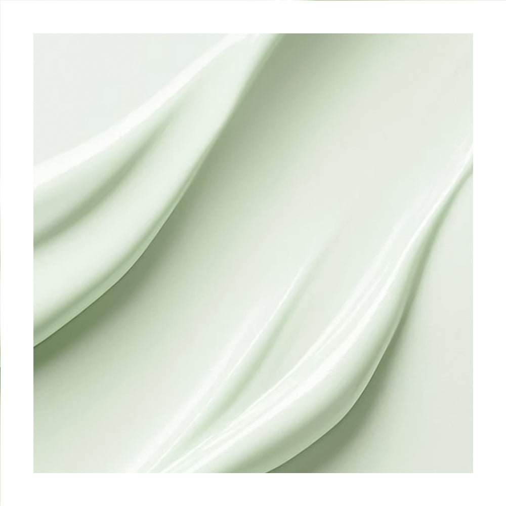 A close-up of a pale mint green cosmetic cream or gel with smooth, flowing folds and a glossy sheen, presented on a white background.