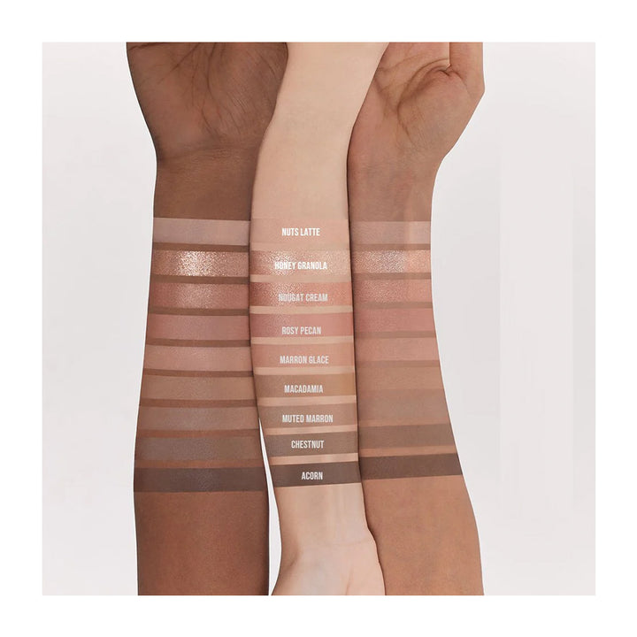 Three arms with swatches of different makeup shades on a white background