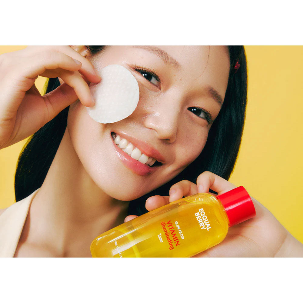 Woman applying a facial patch with a bottle of skincare product against a yellow background