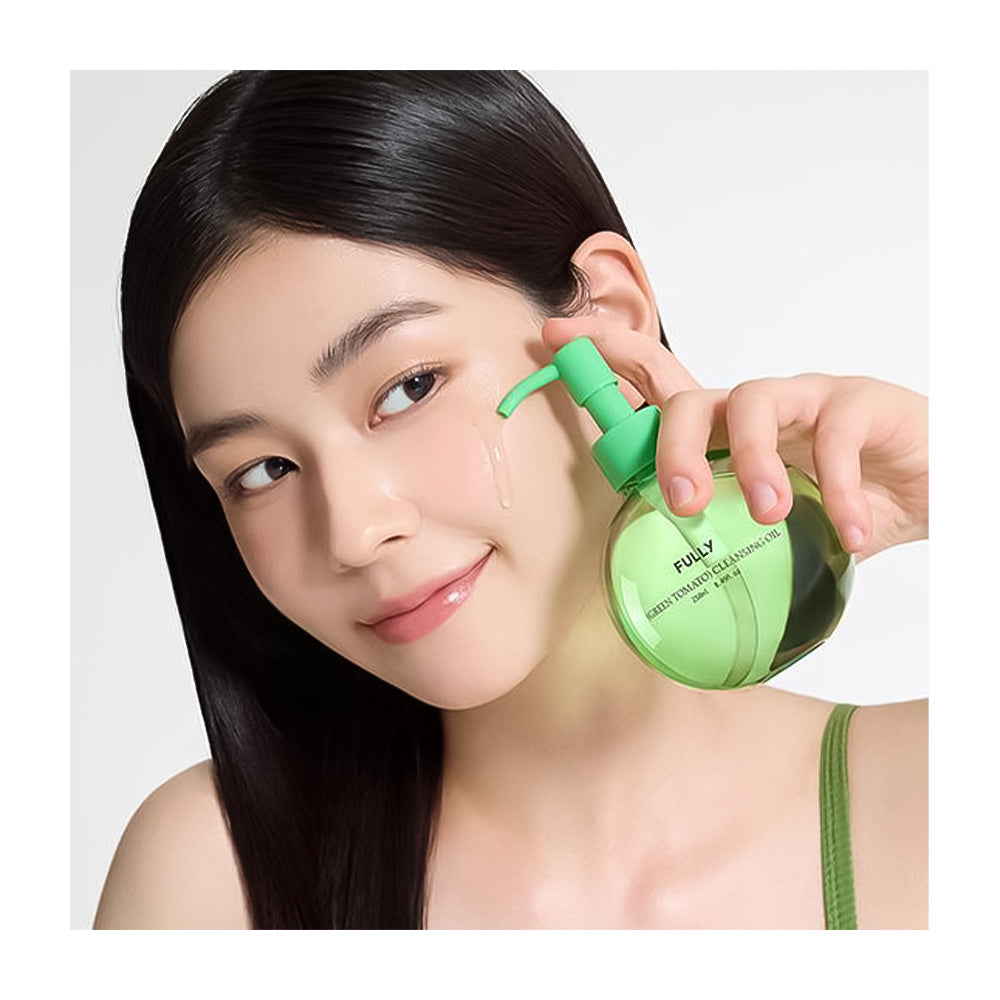 Woman using a green ear cleaning device on her ear with a plain background
