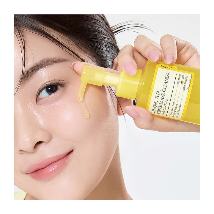 Person applying a yellow skincare product to their face