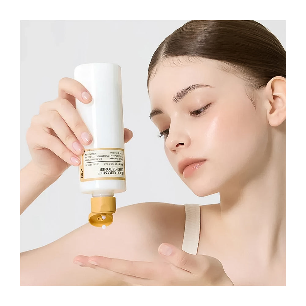 Woman applying skincare product to her arm with a white background