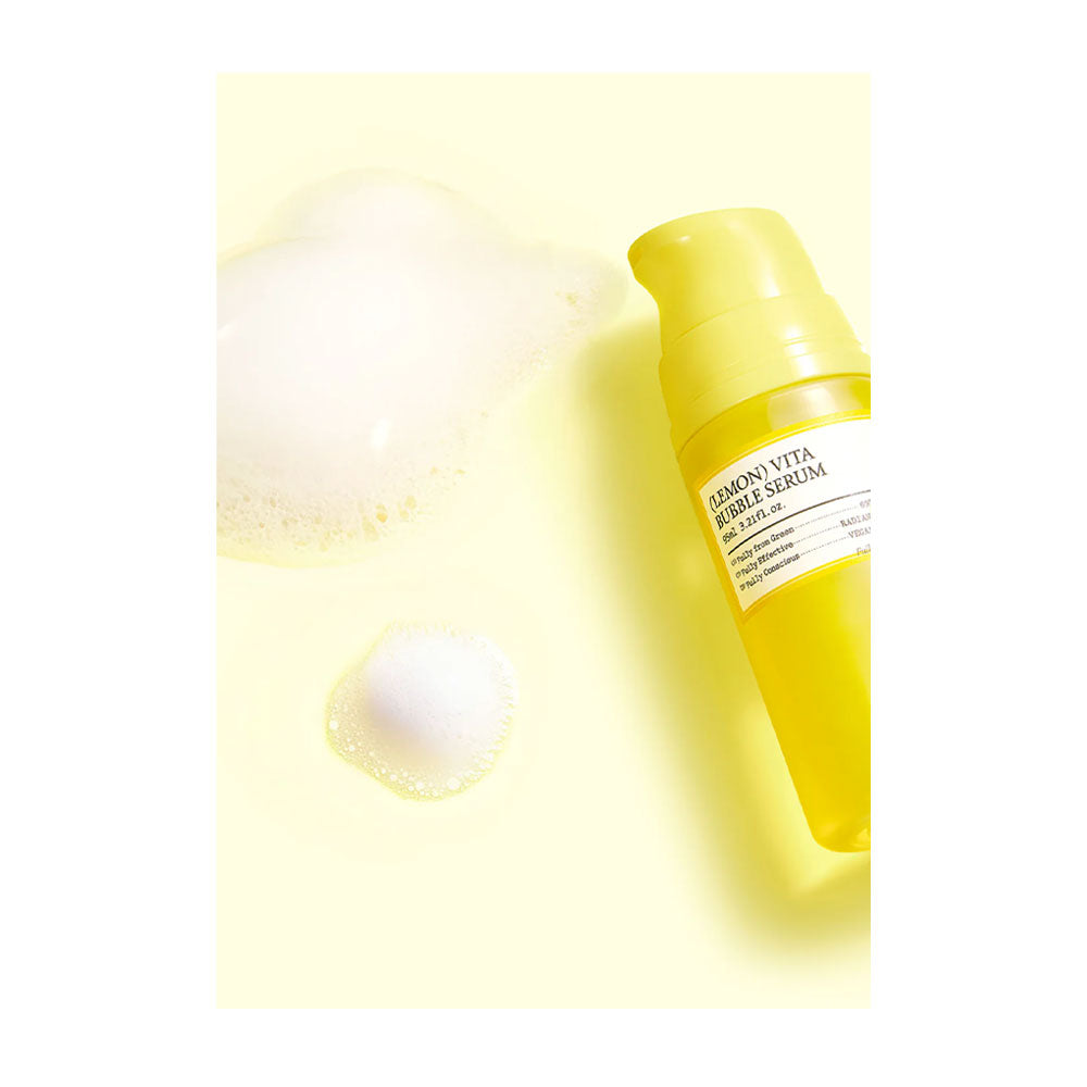 Yellow skincare serum bottle with a droplet on a light yellow background