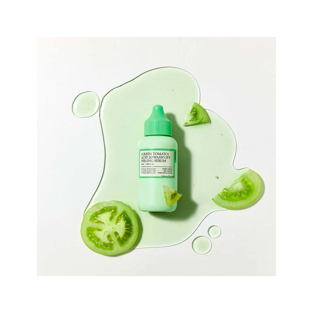 Green tomato peeling serum bottle with slices on a white background