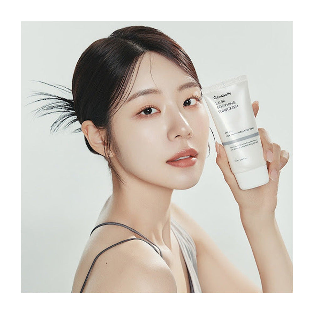 A woman holding a white tube of Qinsanelie Face Soothing Cleanser against a light gray background.