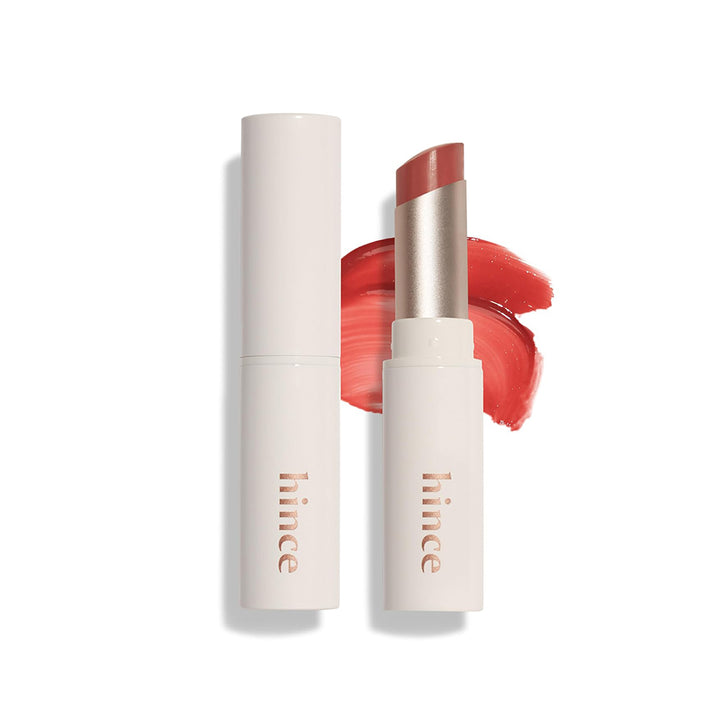 Lipstick with open cap and swatch on a white background, featuring the brand &