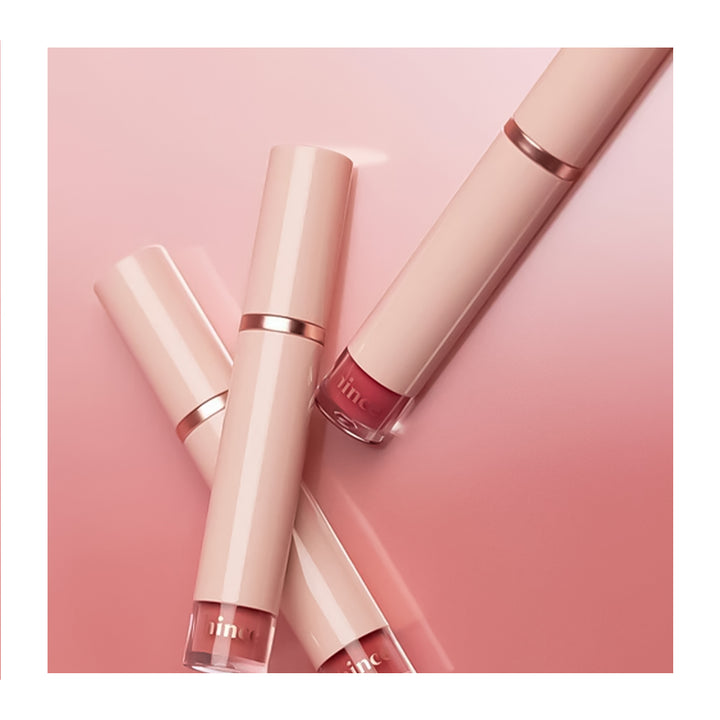 Three lip glosses on a pink background