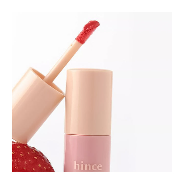 Lip gloss with applicator and strawberry next to it, featuring the brand &