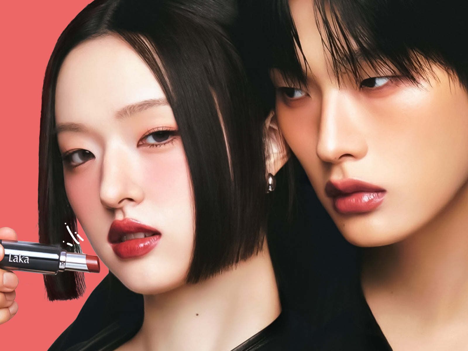 Two models pose in a close-up beauty portrait showcasing red lipstick.