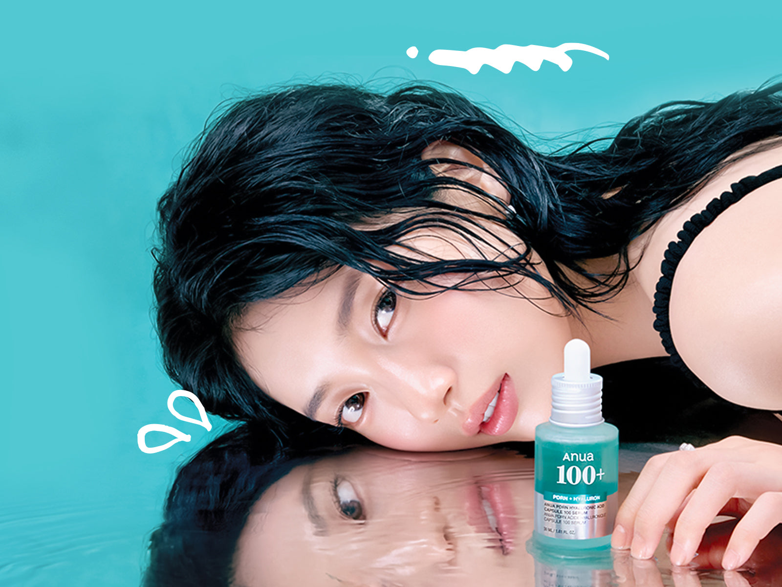 Woman lying on a reflective surface with a bottle of skincare product in front of her against a teal background.