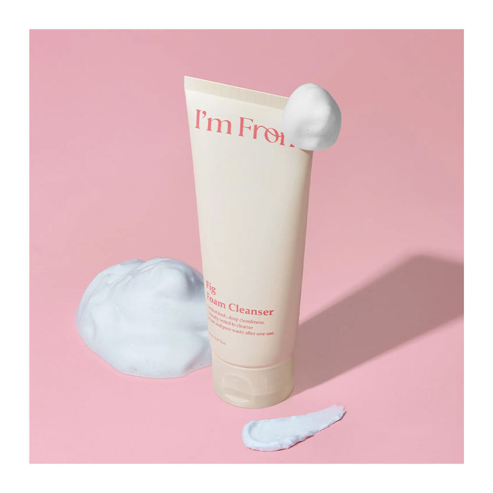 Tube of 'I'm From' cream cleanser with foam on a pink background