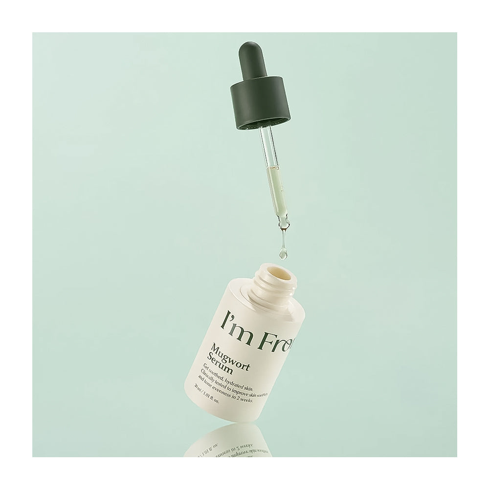 Skincare serum bottle with dropper on a light green background