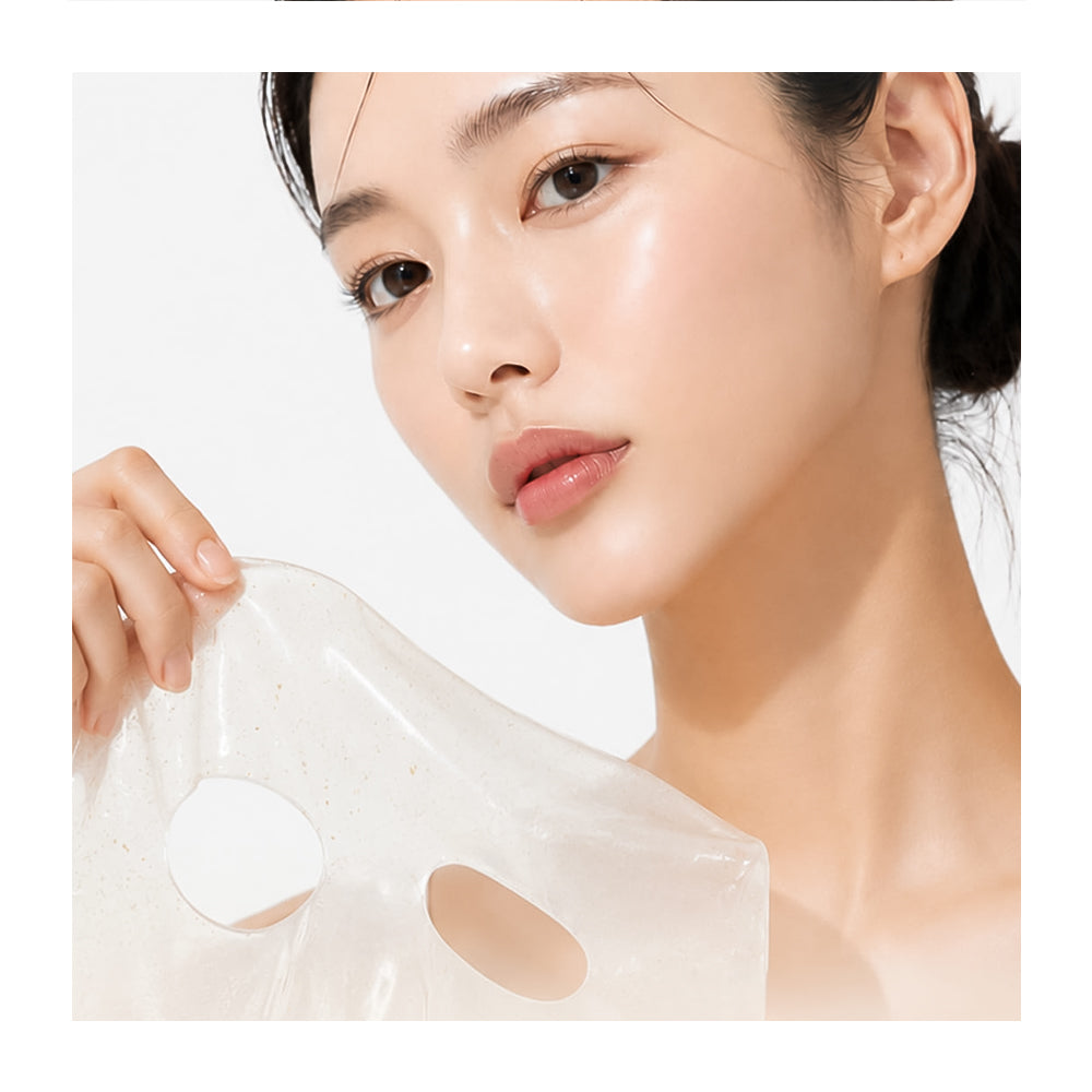 A close-up of a woman holding a translucent, clear sheet mask with eye and nose cutouts against a clean white background.