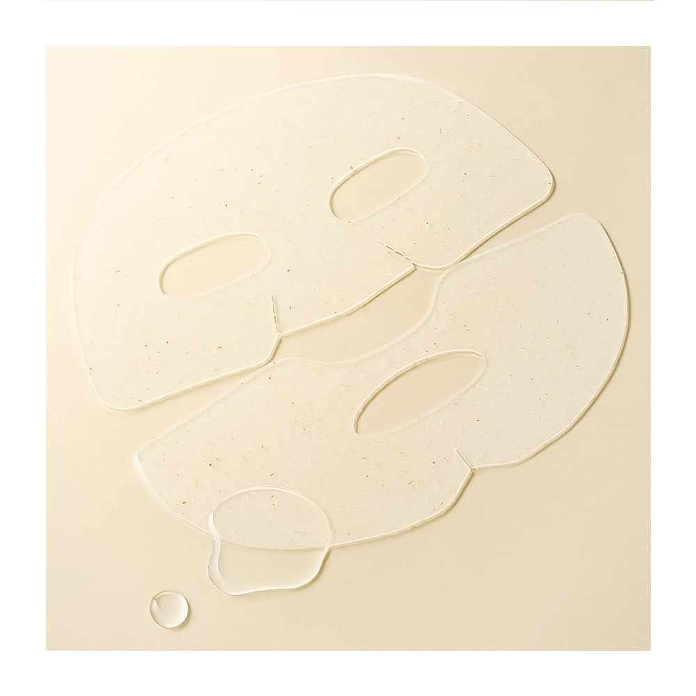 Two translucent, face-shaped sheet masks with embedded tiny specks, displayed on a warm beige background with a small droplet at the bottom left.