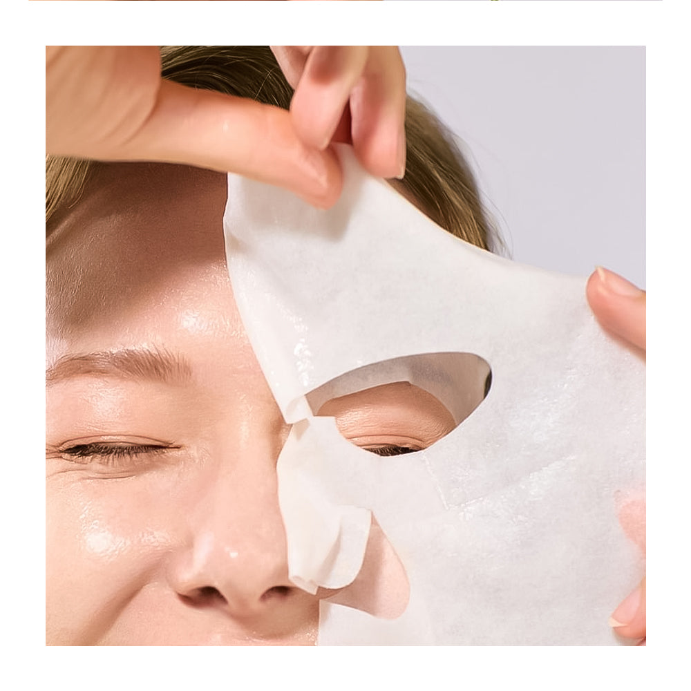Person applying a white sheet mask to their face