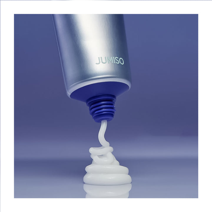 Jumiso product being squeezed out of a tube on a blue background