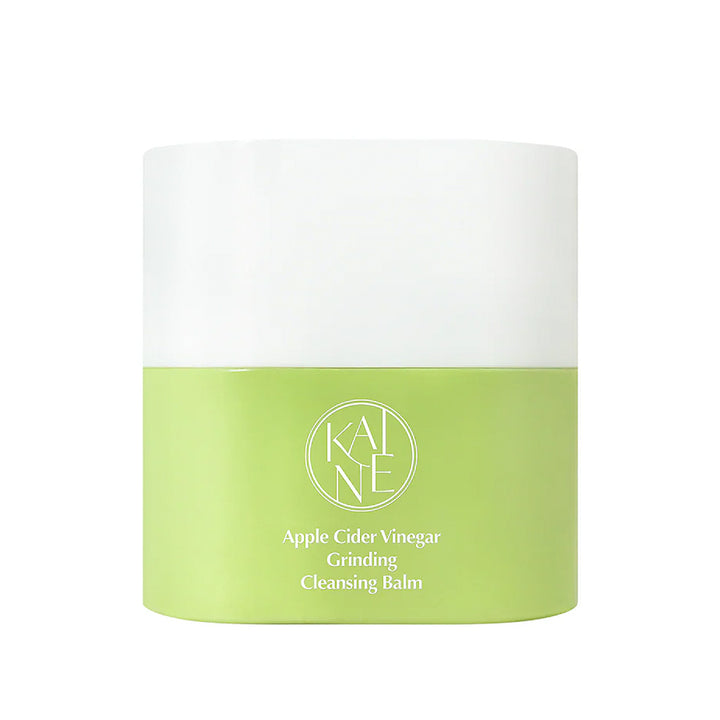 A cylindrical skincare jar of KANE Apple Cider Vinegar Grinding Cleansing Balm, featuring a white upper half and a light green lower half with white text.