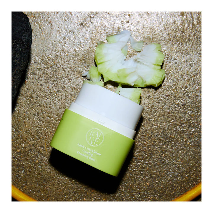 A small cosmetic jar labeled &