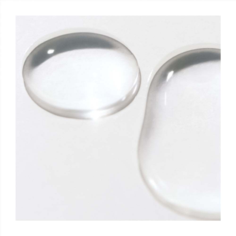 Two clear, glossy liquid droplets on a plain white background, one oval-shaped and one teardrop-shaped.