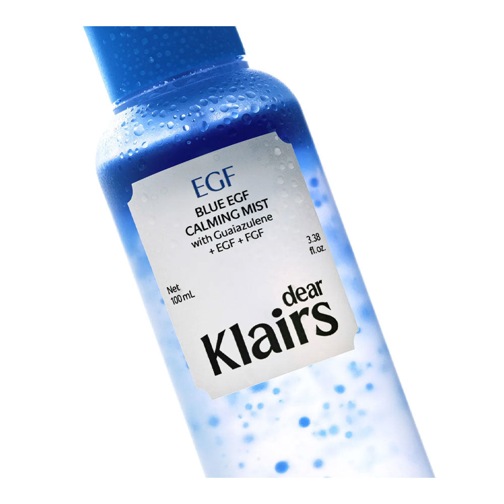 A bottle of Dear Klairs Blue EGF Calming Mist with visible water droplets on the bottle, set against a clean white background.