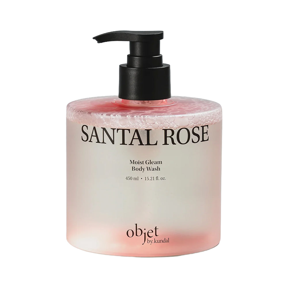 A bottle of objet by kandal Santal Rose Moist Glam Body Wash, featuring a frosted pink and white bottle with a black pump dispenser, set against a plain white background.