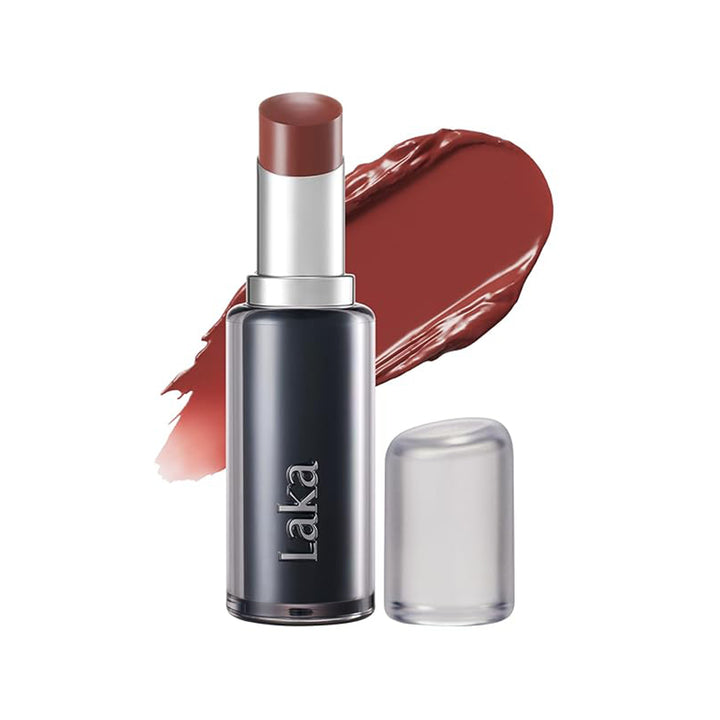 Laka lipstick in a dark metallic gray tube with a silver collar and a warm reddish-brown lipstick bullet, shown with a matching lipstick smear and a clear cap on a white background.