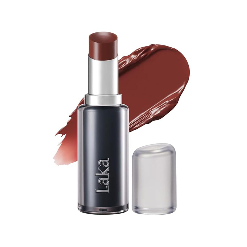 Laka lipstick in a dark metallic gray tube with a silver collar and a deep reddish-brown lipstick bullet, shown with its clear cap off and a matching lipstick smear behind it on a white background.