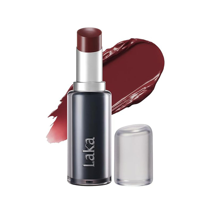 Laka lipstick in a dark berry red shade, shown with the cap off next to a clear cap and a matching lipstick smear on a white background.