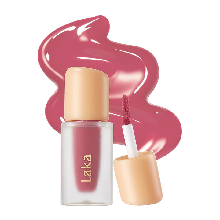 Laka lip product with applicator and pink liquid on a white background