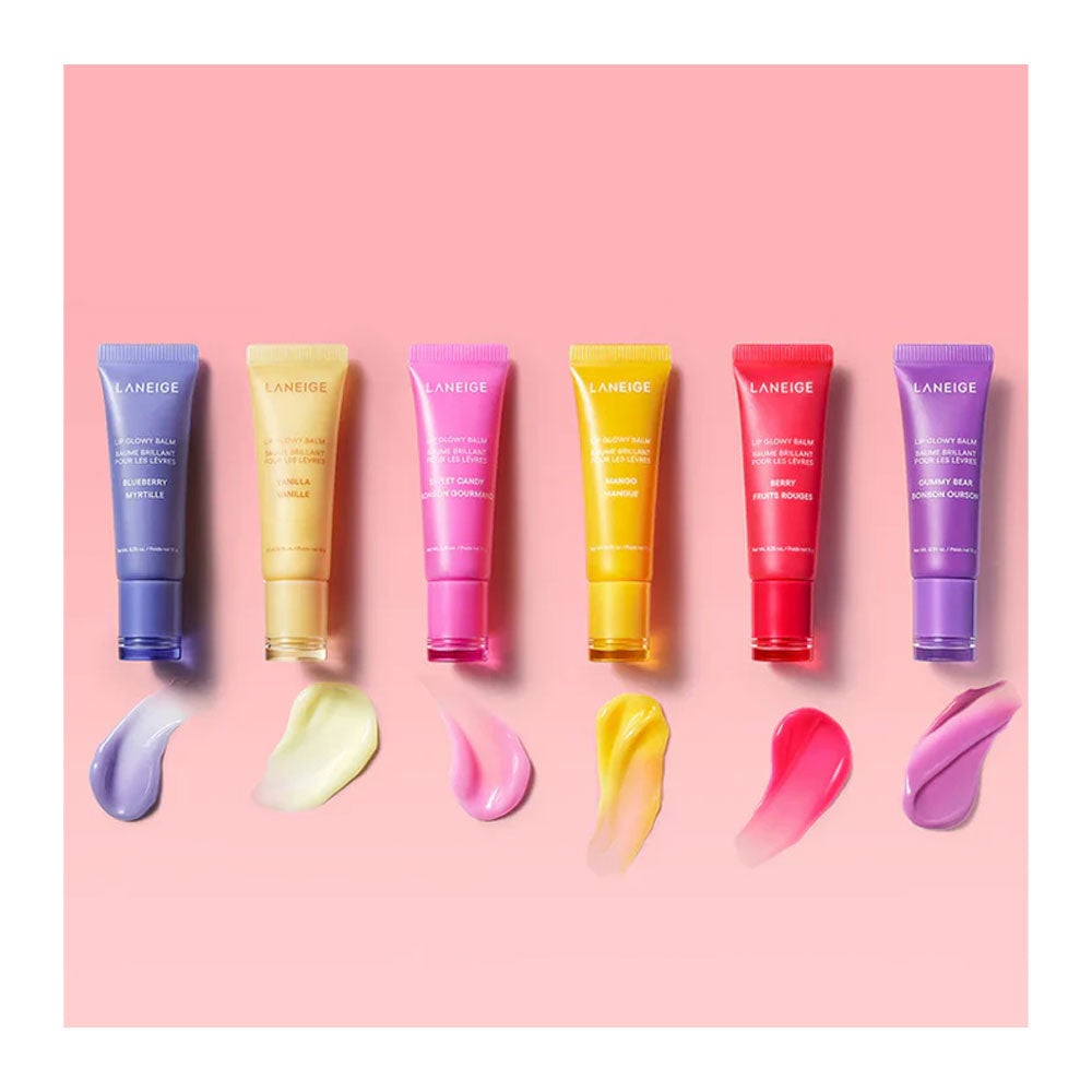 Six tubes of LANEIDE skincare products in assorted vibrant colors (blue, yellow, pink, orange, red, purple) are lined up horizontally on a solid pink background, with corresponding cream swatches displayed below each tube.