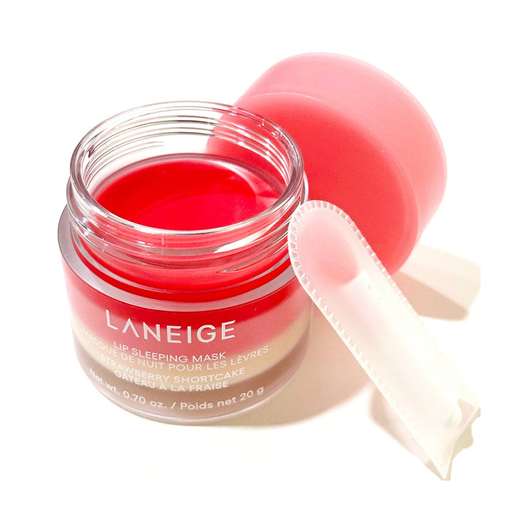 Laneige Lip Sleeping Mask in a clear glass jar with a pink cap, shown open with a white applicator on a white background.