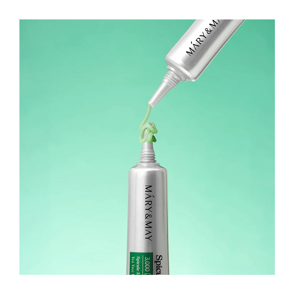Two silver squeeze tubes of Mary &amp; May Spf30 sunscreen cream are shown against a mint green gradient background, with one tube dispensing a squiggle of light green cream.