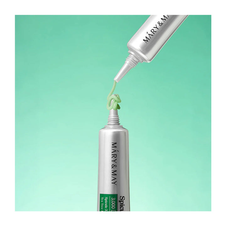 Two silver squeeze tubes of Mary &amp; May Spf30 sunscreen cream are shown against a mint green gradient background, with one tube dispensing a squiggle of light green cream.