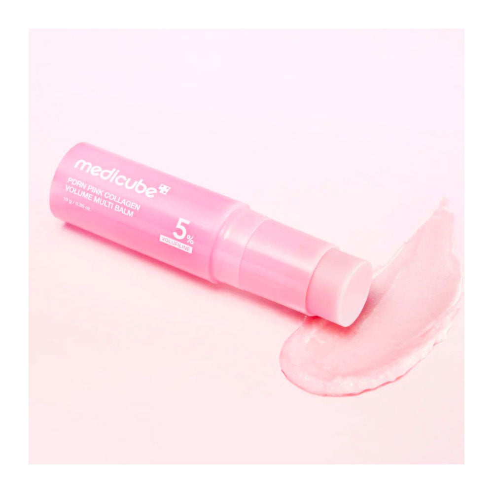 A pink tube of medicube Poin Ewa Collagen Volume Moist Balm lies diagonally next to a swatch of pale pink balm on a solid light pink background.