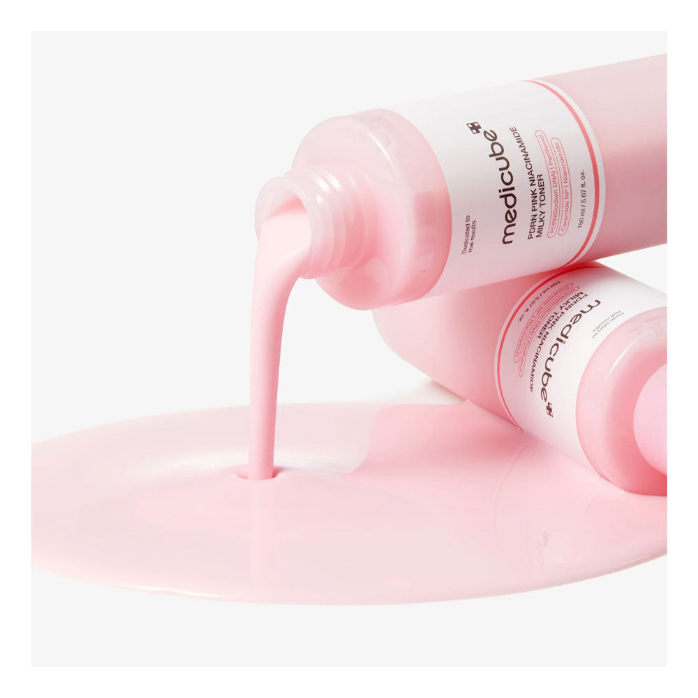 Two pink bottles of Medik8 Prime Light Moisturizer with liquid being poured onto a white surface, creating a smooth pink pool.