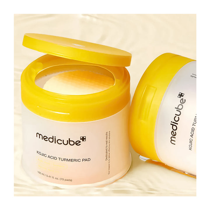 Two jars of Medicube Kojic Acid Turmeric Pad on a beige background