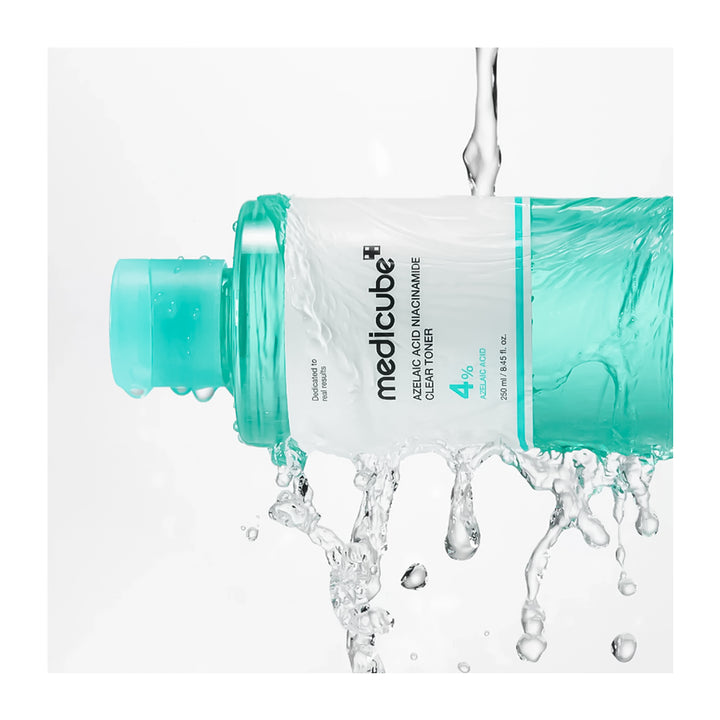 Medicube toner bottle with water being poured into it on a white background