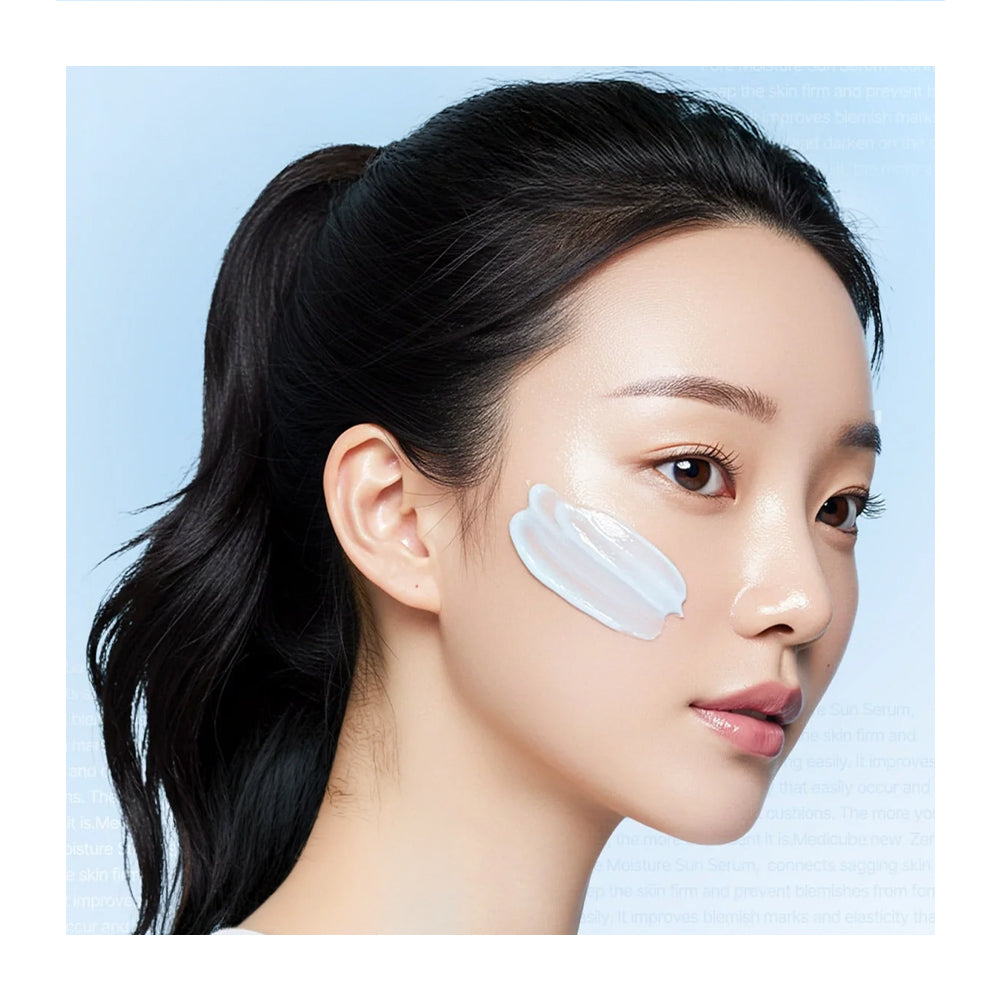 Woman with a skincare product applied to her face against a light blue background