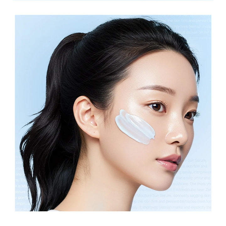 Woman with a skincare product applied to her face against a light blue background