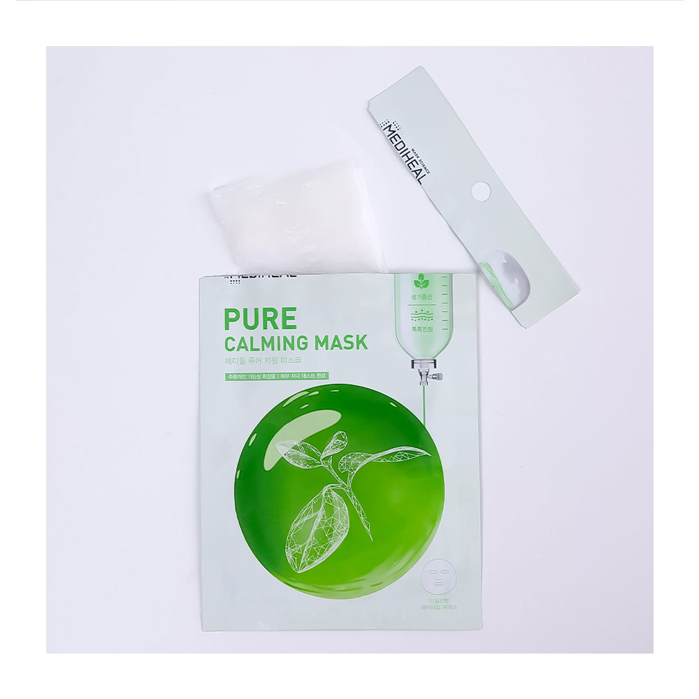 A sheet mask package labeled 'PURE CALMING MASK' with a green circular leaf graphic, shown with a translucent patch and a white applicator strip on a plain white background.
