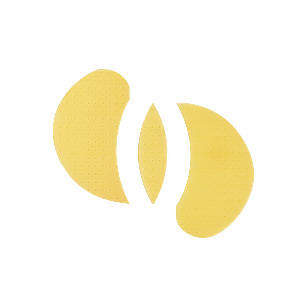 Three yellow eye patch pads with a textured, dotted surface, arranged symmetrically on a plain white background.