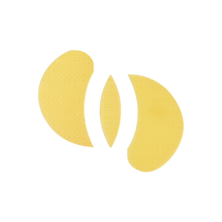 Three yellow eye patch pads with a textured, dotted surface, arranged symmetrically on a plain white background.