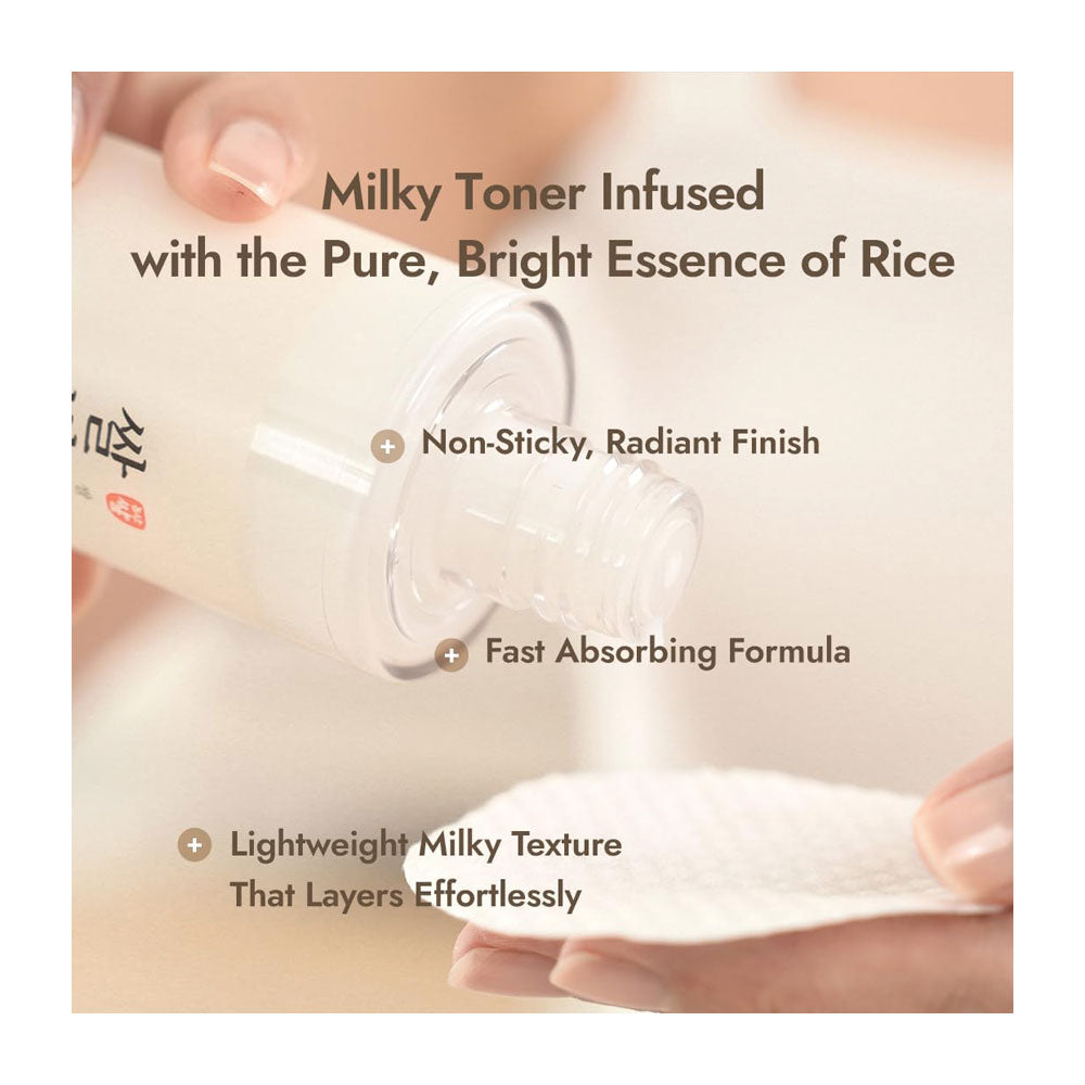 A close-up of a hand holding a clear bottle of toner and tilting it to pour a milky liquid onto a white cotton pad. Text overlays describe the toner as milky and infused with rice essence, with additional benefits listed.